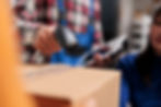 retail-storehouse-employees-doing-inventory-management-while-scanning-packages-postal-serv