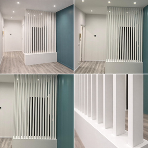 Modern interior with white slatted partitions and teal wall.