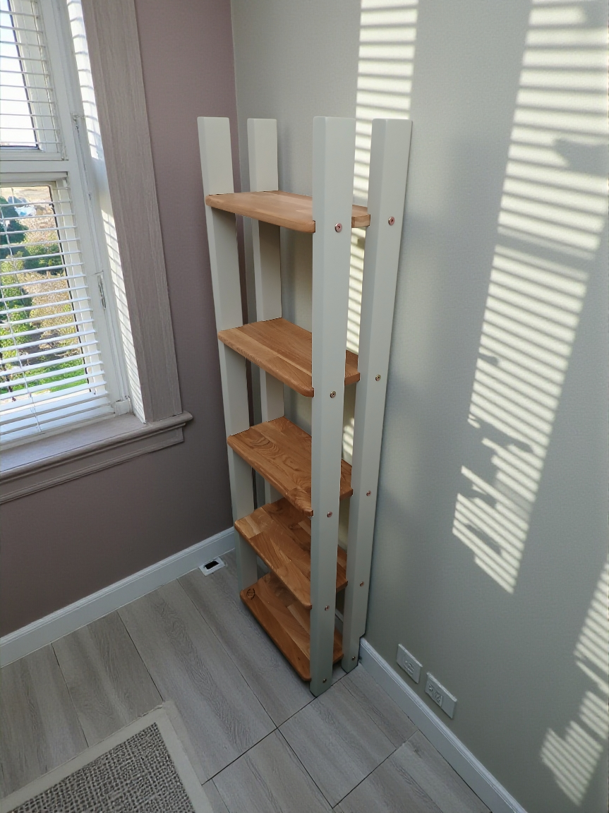 Thumbnail: Tall narrow bookcase made from oak next to a window