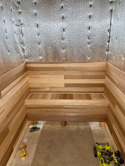 Cedar wall cladding installation for custom sauna in Edmonton