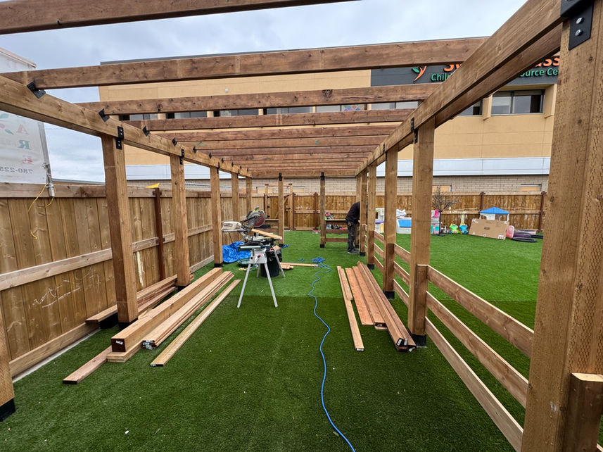 Installation of railings inside a custom outdoor pergola structure during construction in Edmonton