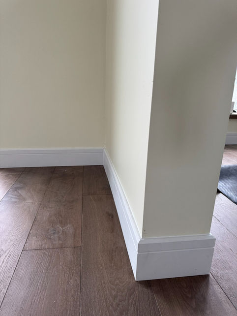 Detailed view of a clean baseboard corner and wall transition in Boyle, Alberta