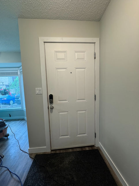 Modern door casing and flat stock baseboards professionally installed in an Edmonton home