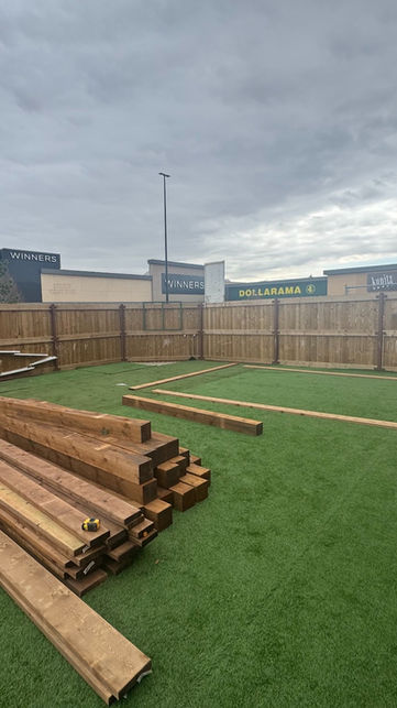 Pressure-treated lumber delivered and laid out for custom pergola construction in Edmonton