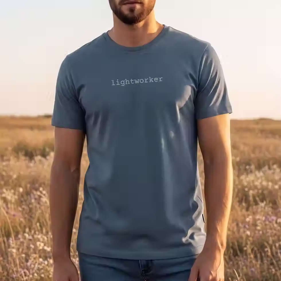 Man wearing minimalist text-based lightworker t-shirt in blue jean with the word 'lightworker' small in the centre of chest