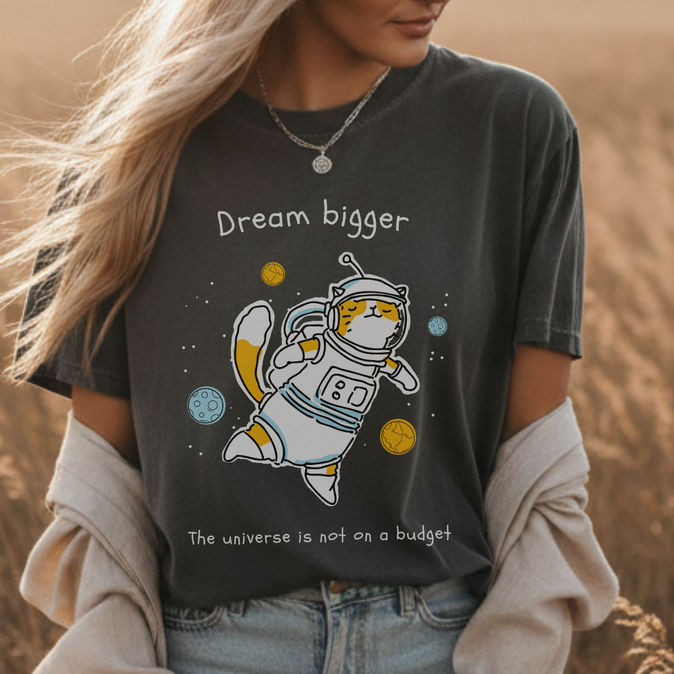 Woman wearing grey "Dream Bigger, The Universe Is Not On A Budget" Manifestation Tee for Women with astronaut cat