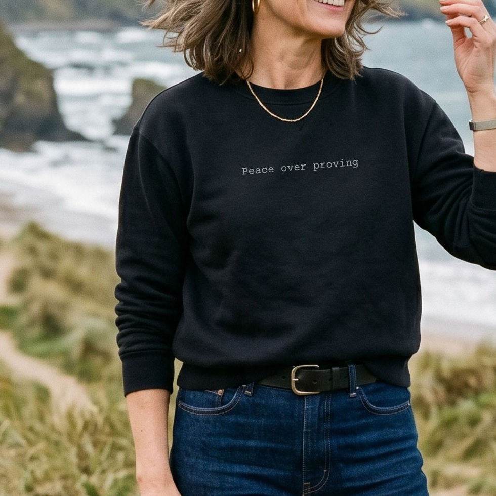 Woman wearing black "Peace Over Proving" Soul-Aligned Minimalist Awakening Sweatshirt_VISUAL AWAKENING ART