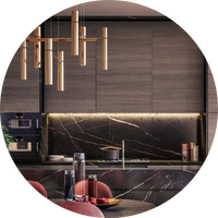 Modern kitchen design with marble countertops and a stylish hanging light fixture.