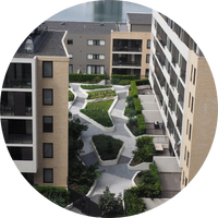 Aerial view of modern apartment complex with landscaped gardens and Carrington Place.