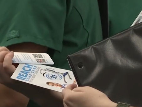 Nursing student looking at a Reach Home Care flyer