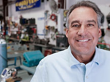 Mark Poyden smiling inside RV repair garage