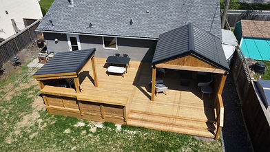 pressure treated wood deck in winnipeg, with metal roof pergola gazebo, covered bbq area, bar area and wooden railing