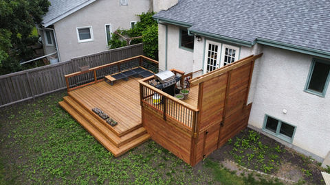 wood deck with wrap around staircase and privacy screen
