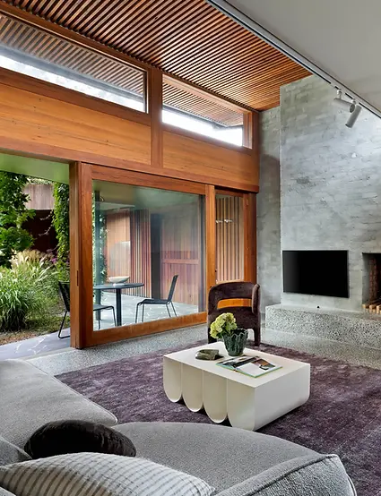 Luxury staged living room Melbourne with gray sectional and indoor‑outdoor flow