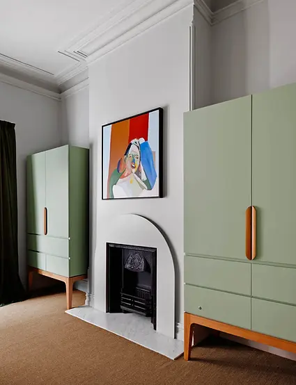 Staged classic living room Melbourne with painted cabinetry and feature artwork