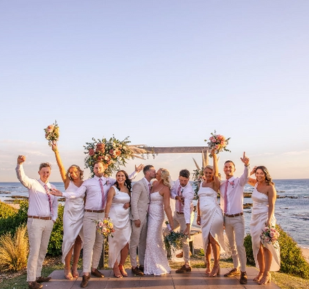bride and groom kissing on alter near shore.png