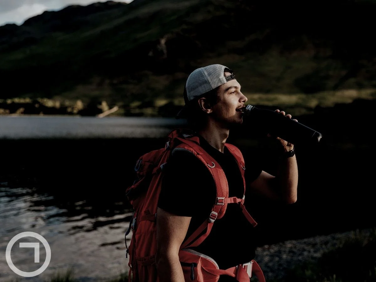 A person drinking water from his bottle