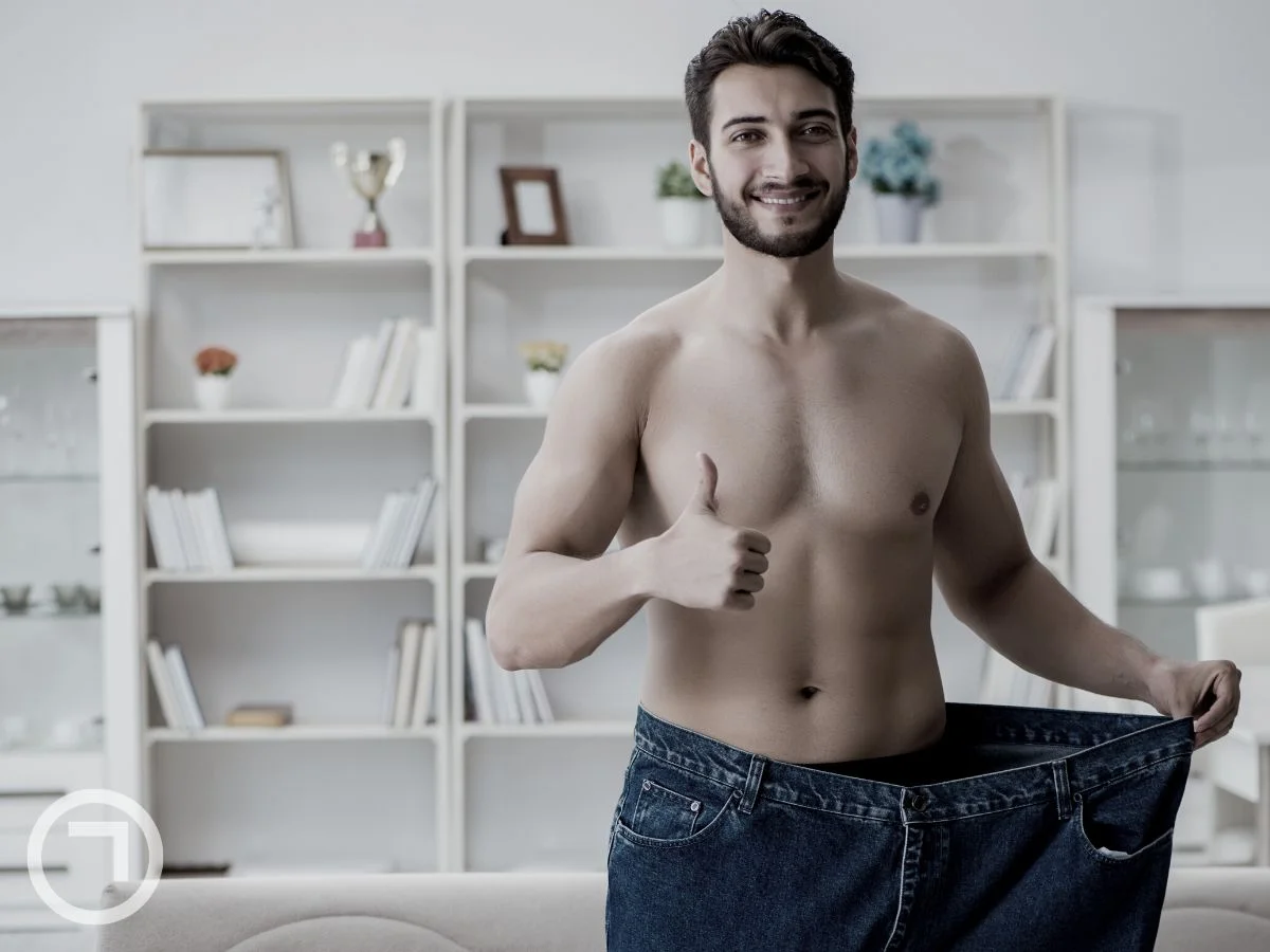 A man holding his pant by the waist