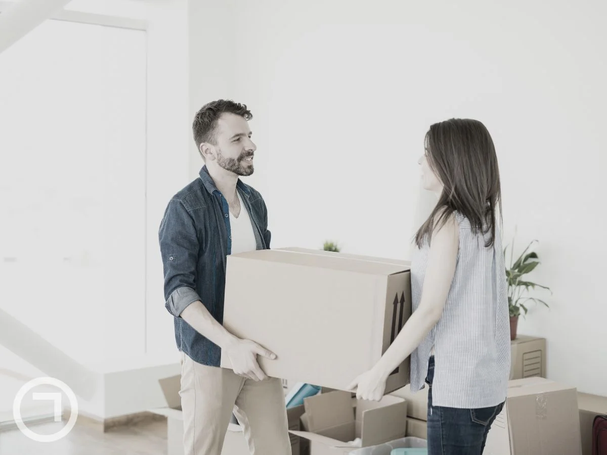 A couple handling a box together