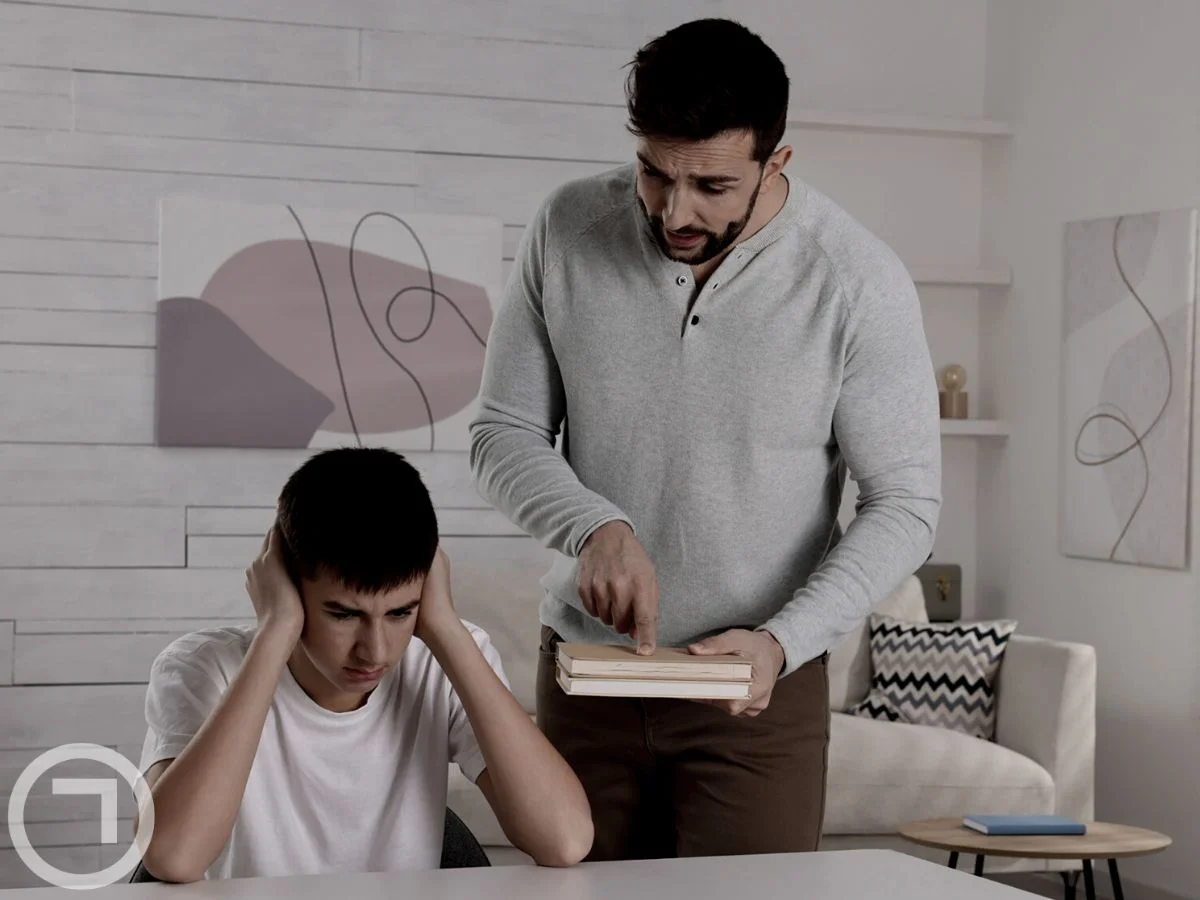 A father scolding his son