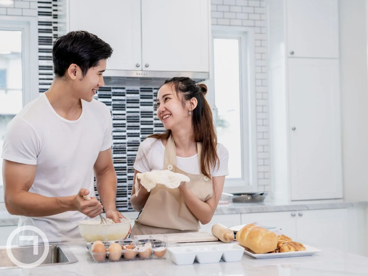 A couple cooking and baking together