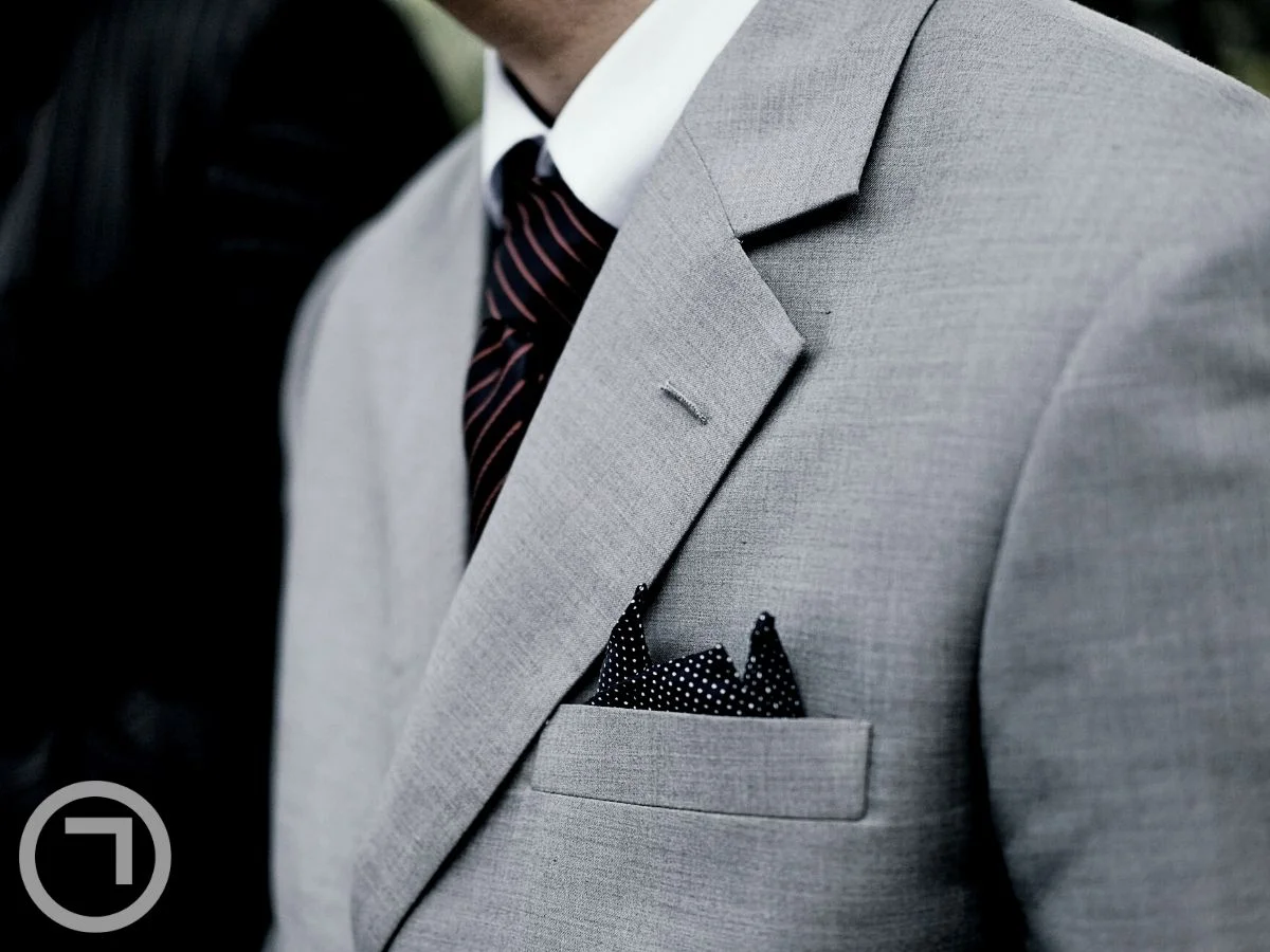 A pocket square in a man's blazer pocket