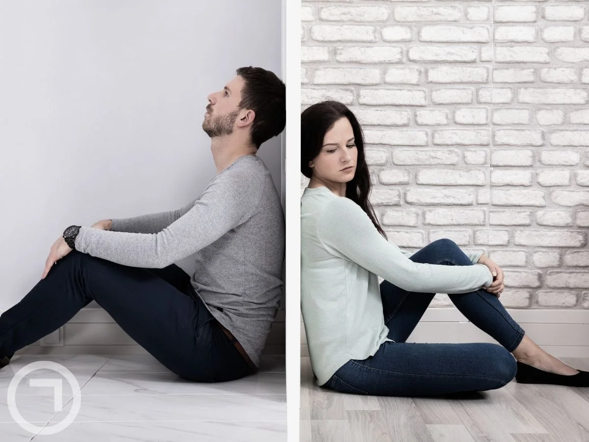 A man and woman sitting in different spaces
