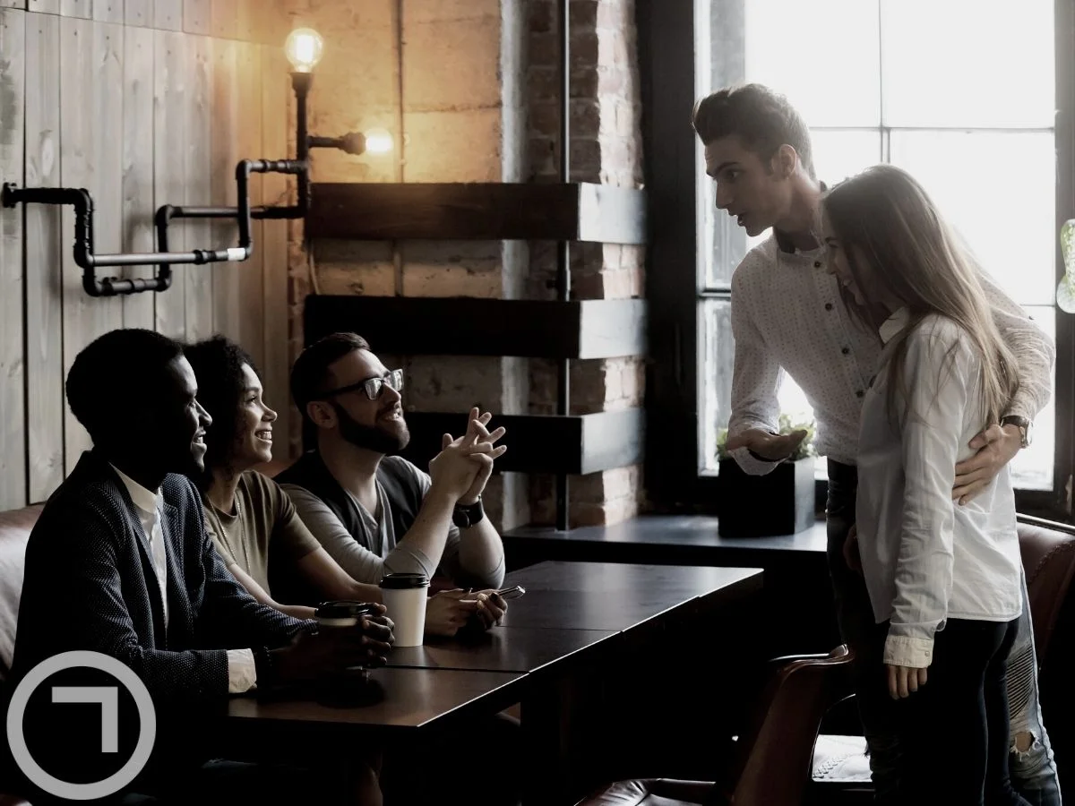A man introducing his partner to his friends