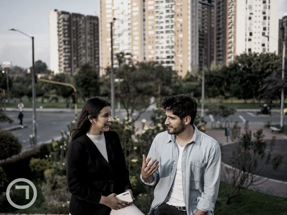 Two people talking on a road