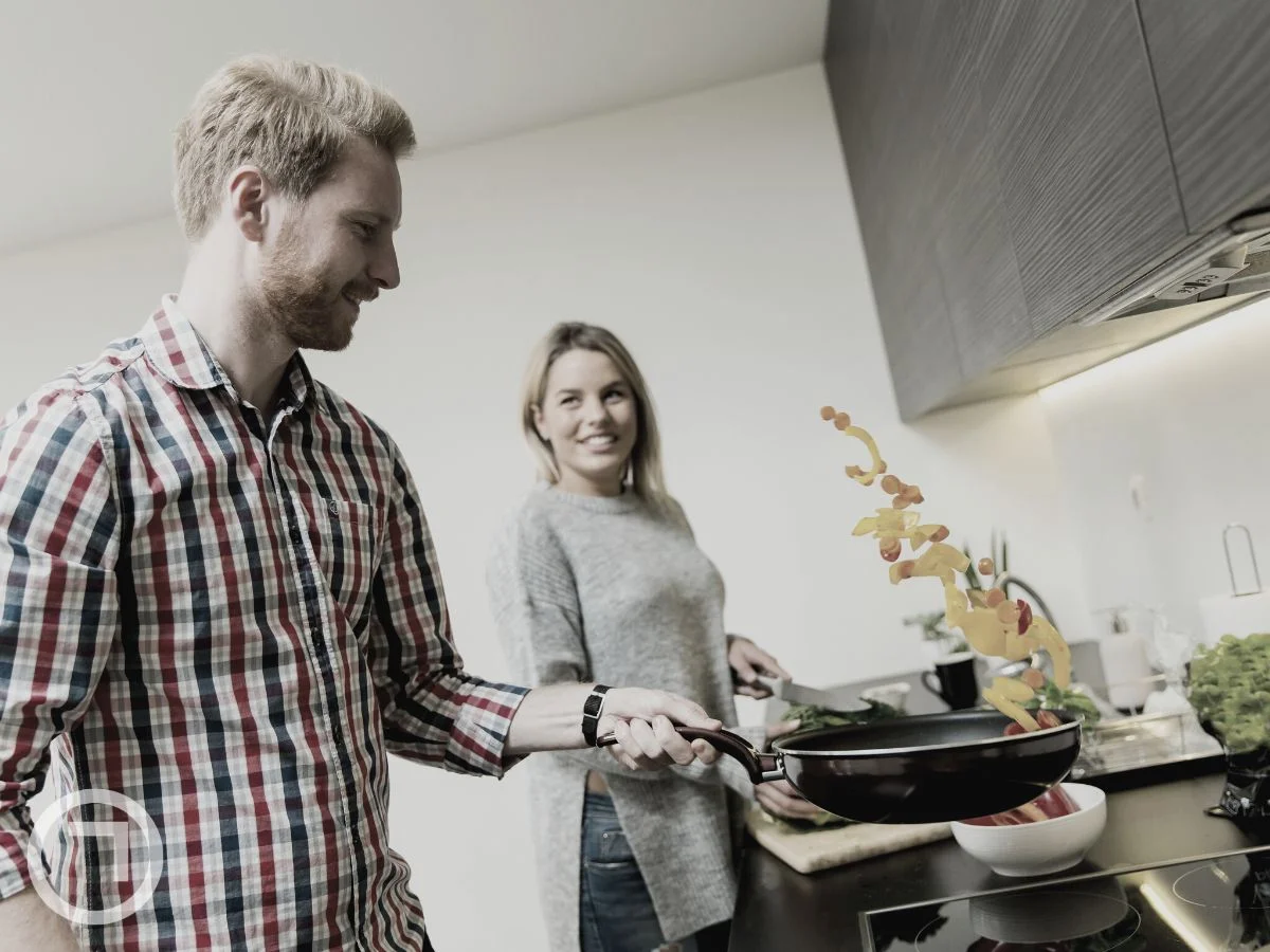A couple cooking together in the kitchen