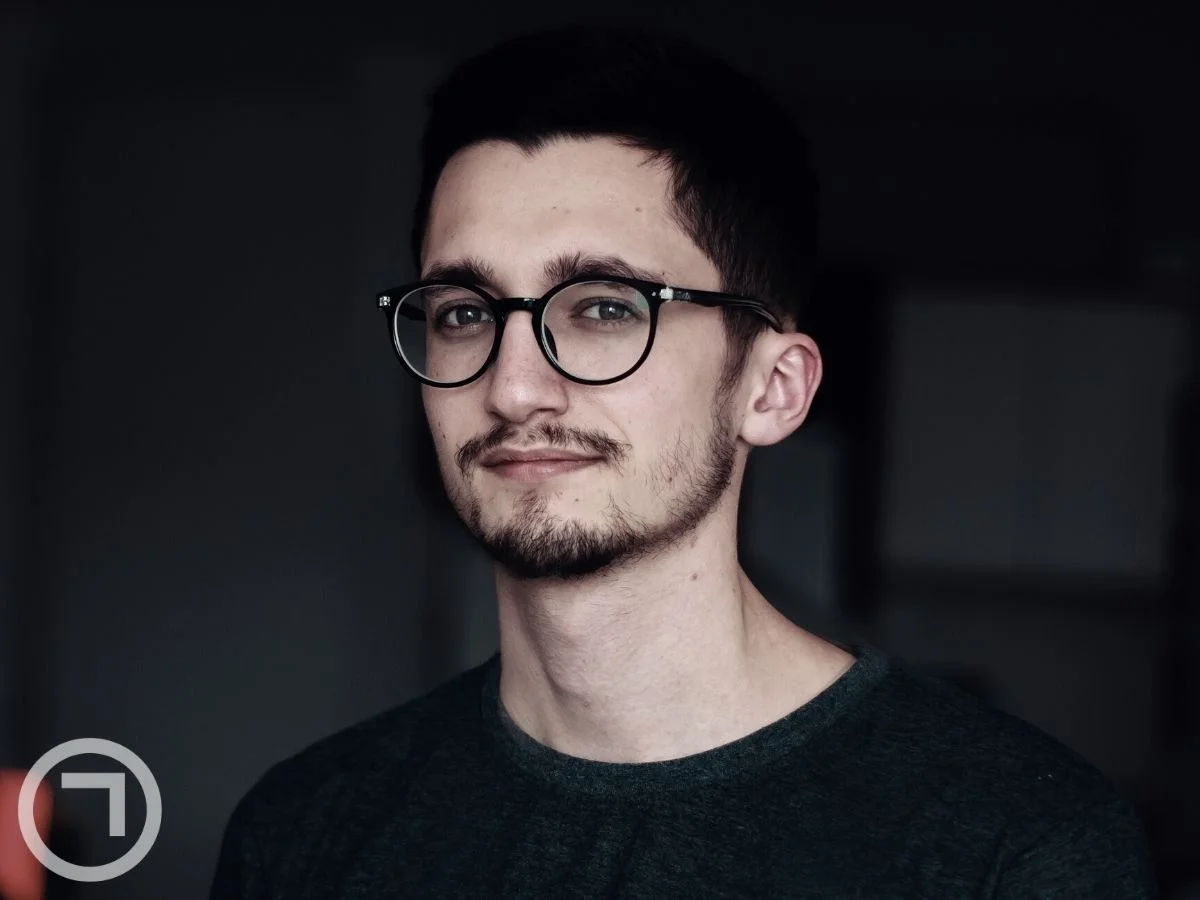 A young man wearing glasses