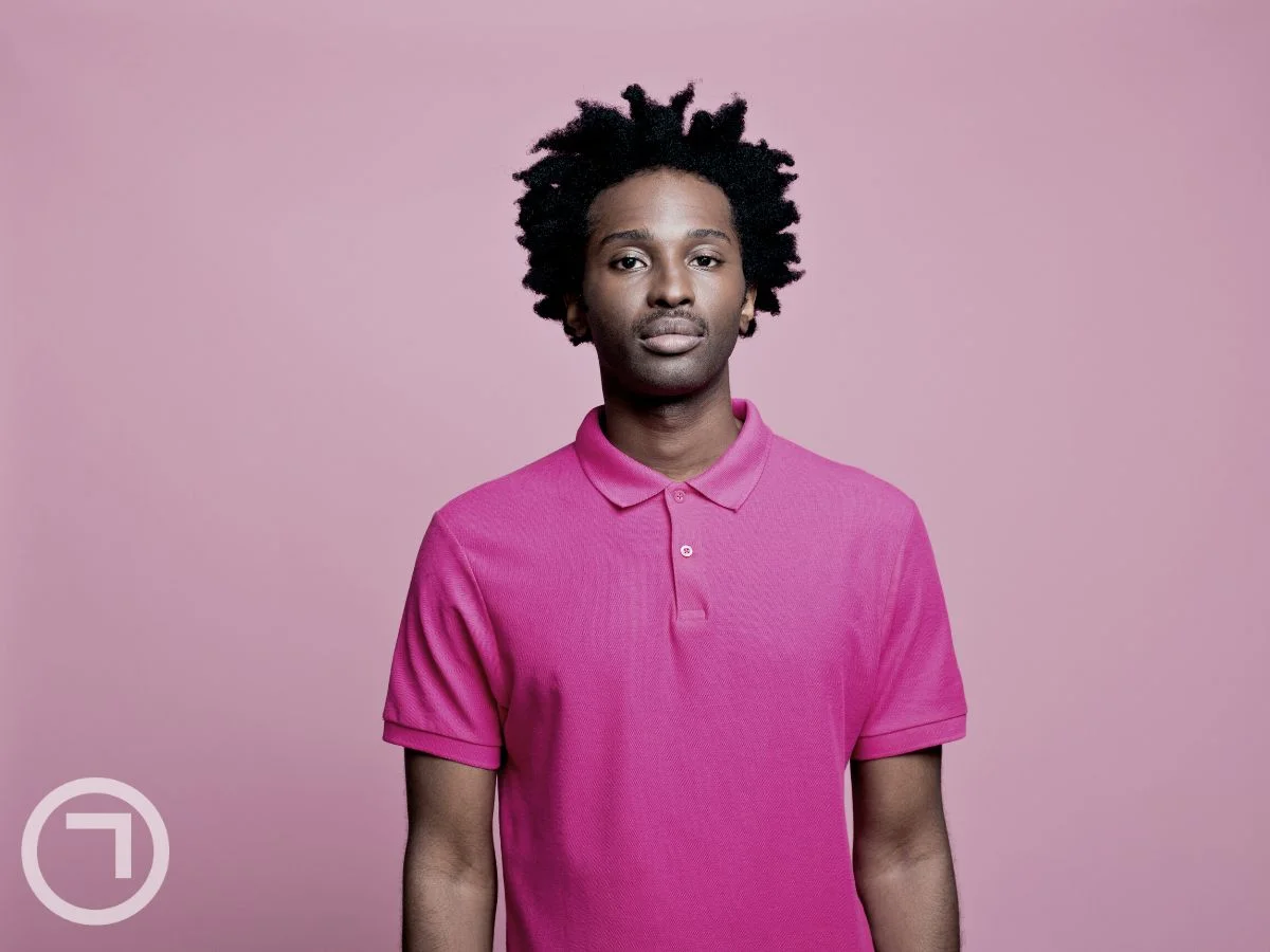 A man wearing a pink tshirt