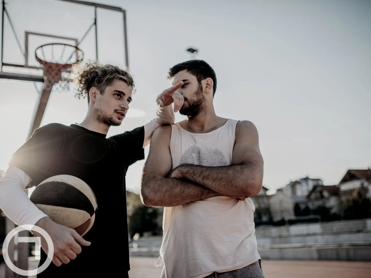 Two friends playing basketball together