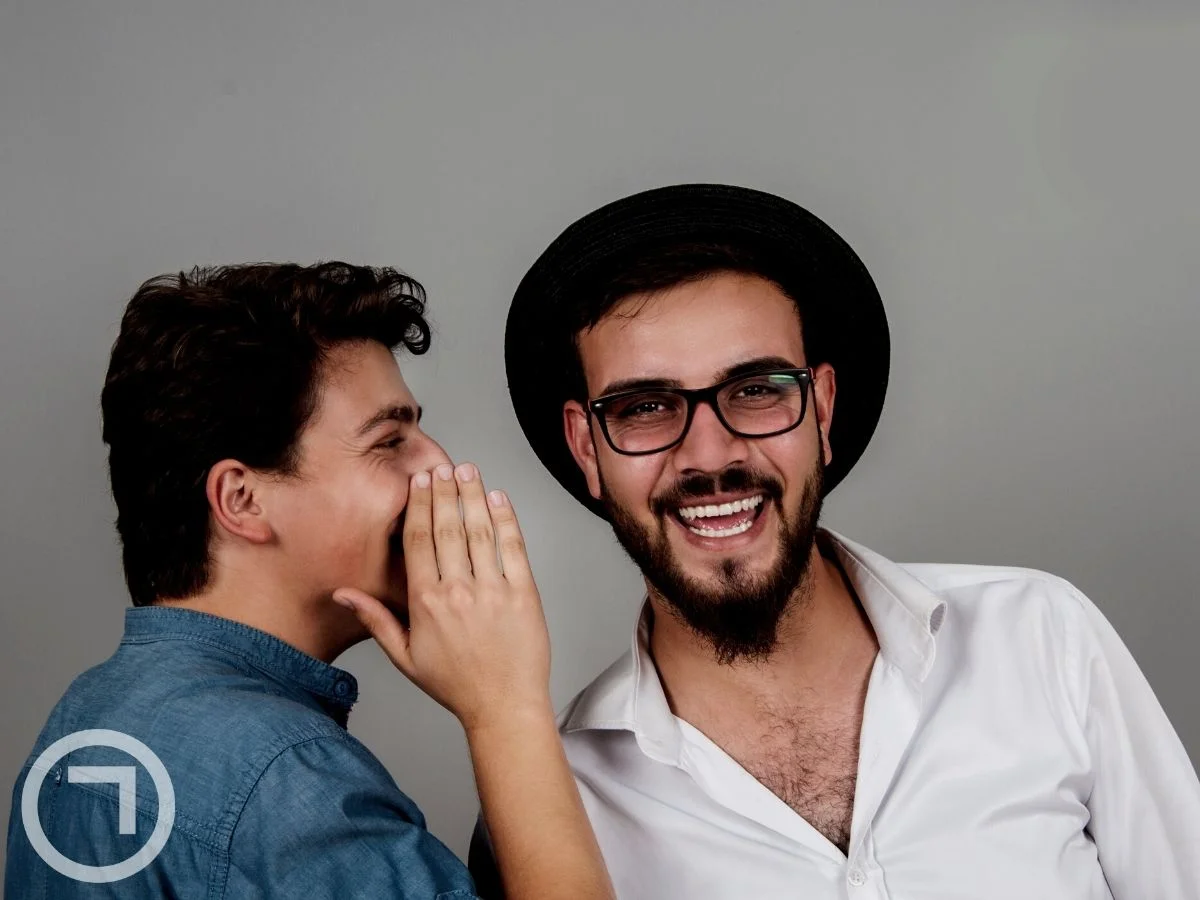 A boy telling a secret to his friend