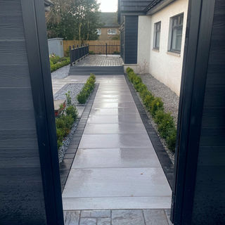 Rain-slicked grey path on other side of opening