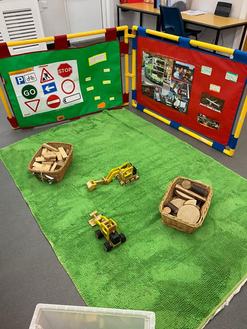 Explorative play with wooden building blocks and trucks