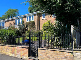 Standard iron gate and railings fitted to the wall of the front garden