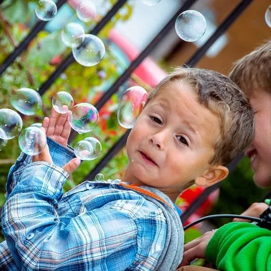 Little boy playing with bubbles