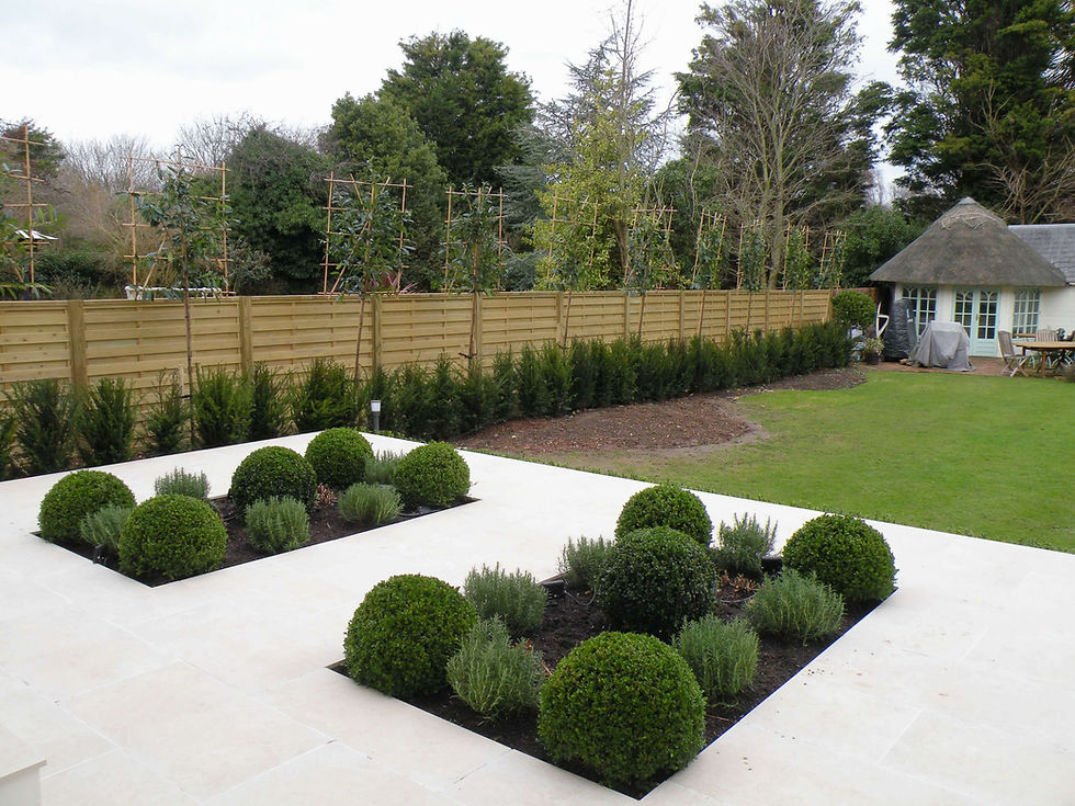 A view of a newly laid garden design complete with cream porcelain tiles