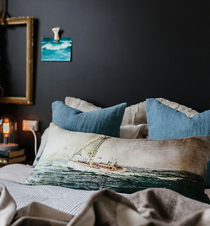 A day on the bay cushion lying on a bed