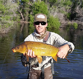 Man holding large carp while on a guided fly fishing trip on Lake Isabella, California