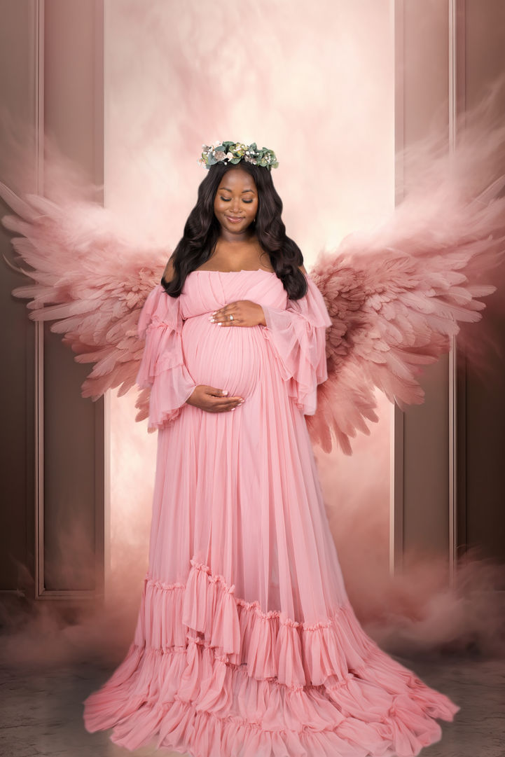 Beautifully edited studio maternity photo featuring a radiant pregnant woman in a flowing gown, posing gracefully against a dreamy, floral background. The soft, pastel flowers and professional lighting create a romantic, elegant atmosphere that highlights her baby bump and maternal glow. Ideal for floral maternity photography inspiration, studio pregnancy photoshoot ideas, and timeless motherhood portraits.