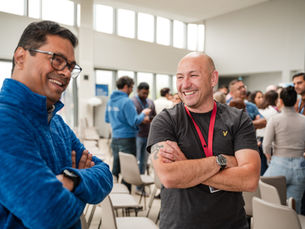 two men working in corporate laughing at internal event