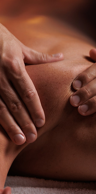 Handsome man having restorative shoulder massage in spa, enjoying relaxing atmosphere, reb