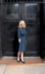 Christine Buss posing in front of a black door.