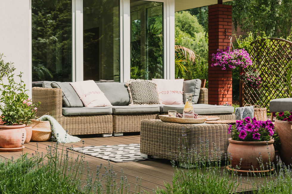 Pleasant outdoor seating area on a deck featuring planted containers and pots. 