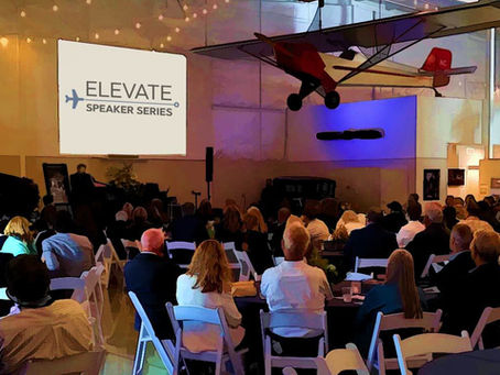 A dinner event with people sitting watching a presentation.