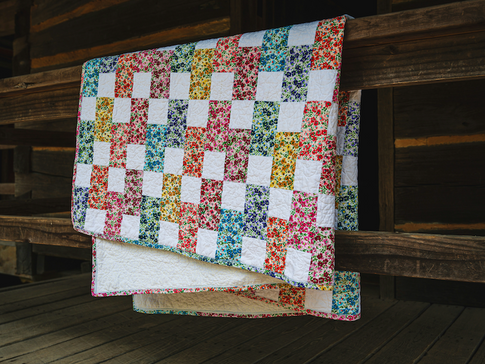 Quilt hanging on a railing