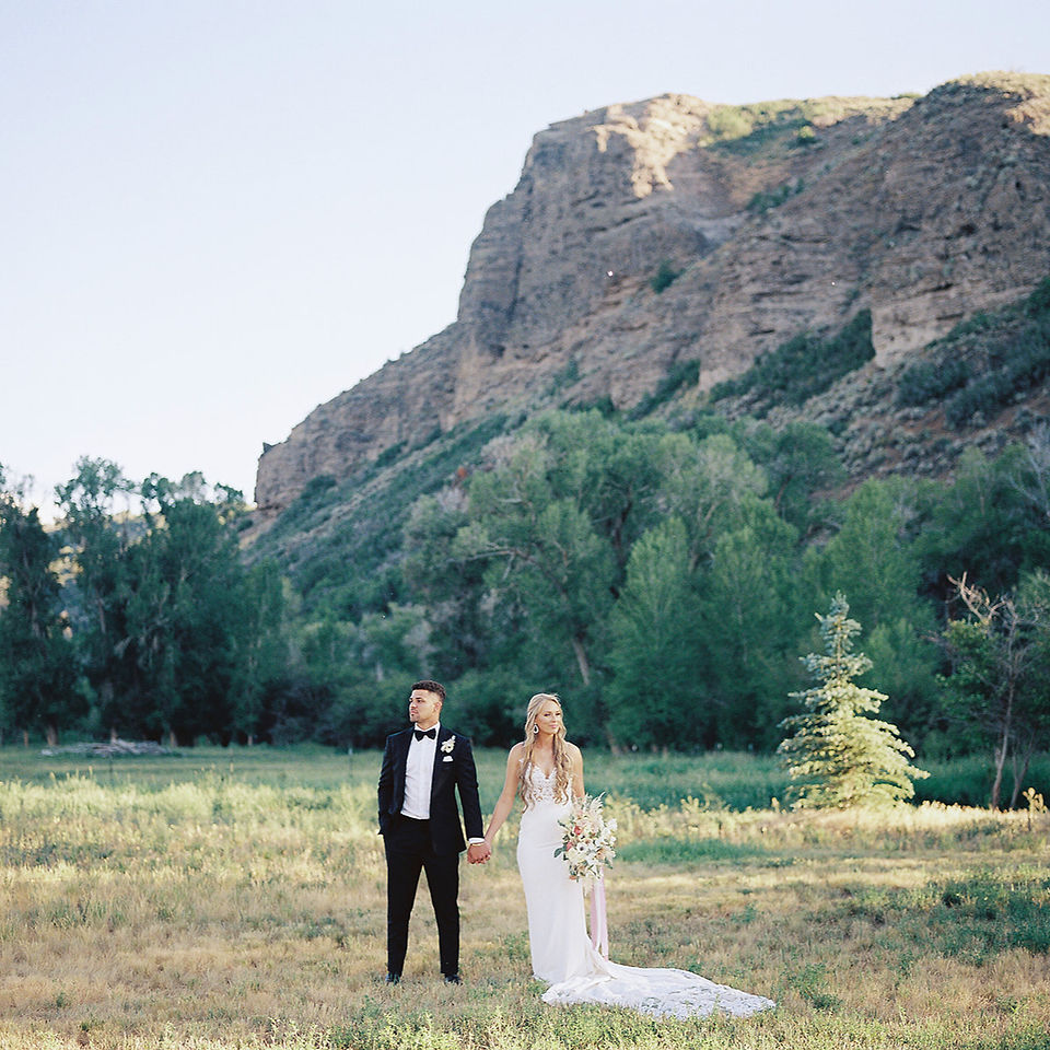 Bride and groom portrait in a scenic Utah mountain landscape during a refined destination wedding weekend