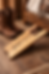 Handcrafted white oak boot jack designed for removing boots, displayed in a rustic interior setting